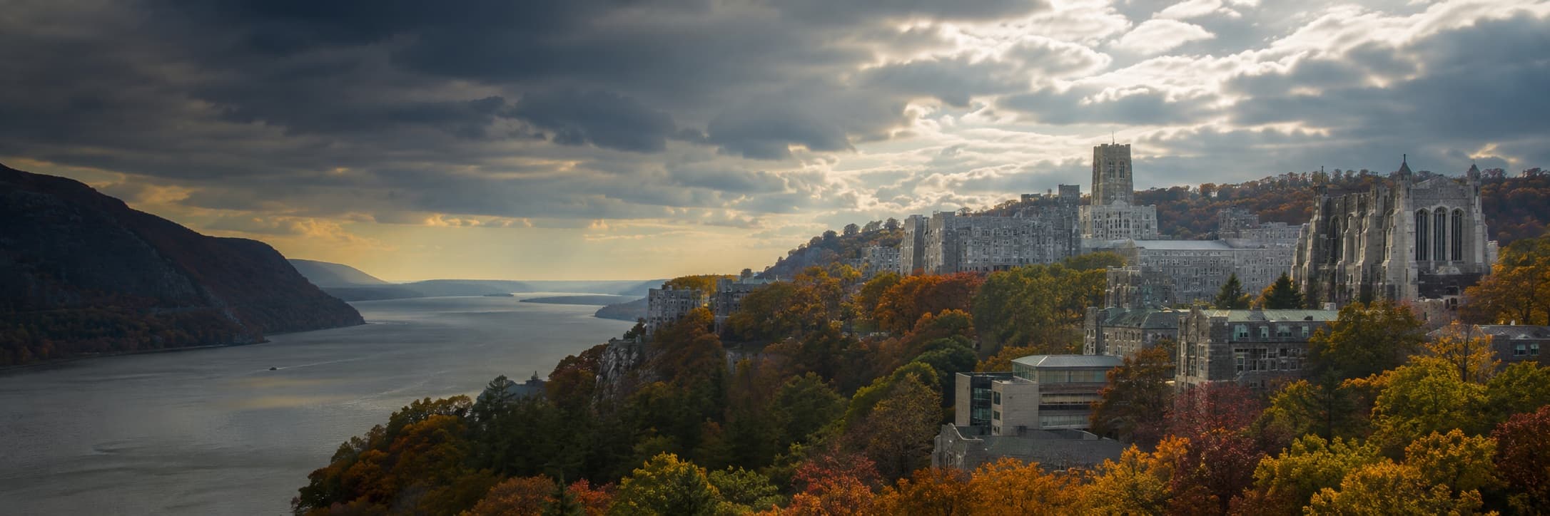 West Point overlooking the Hudson River, gray granite Gothic buildings with autumn foliage